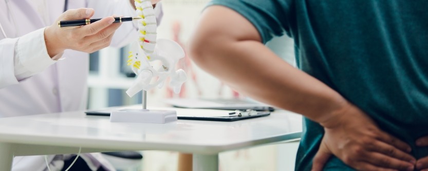 chiropractor in St Pete evaluating patient with back pain and mobility issues
